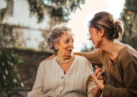 an older woman talking to a younger woman